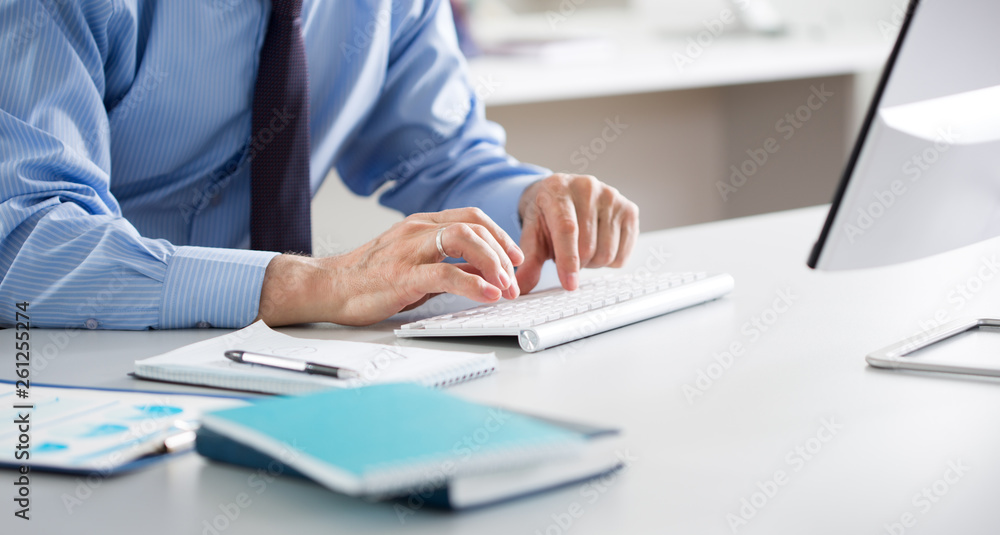Close-up of hands senior businessman working with computer Close-up of hands senior businessman working with computer
