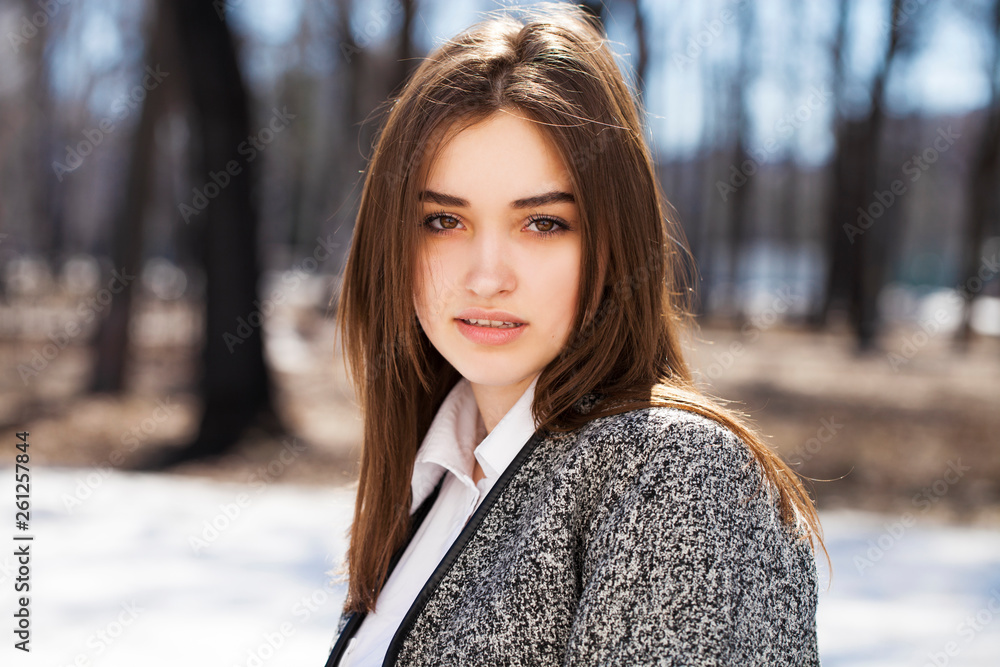 Close up. Young beautiful brunette girl in gray coat Close up. Young beautiful brunette girl in gray coat