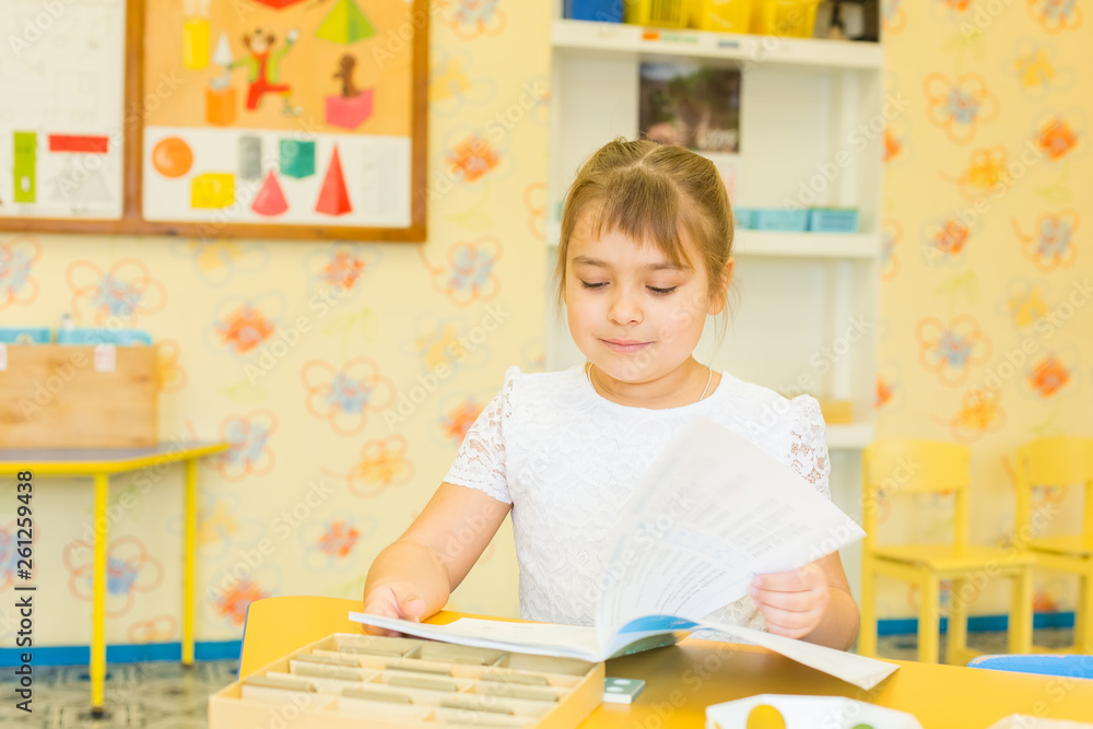 Fototapeta premium Caucasian girl in primary school. Childhood, education, knowledge concept