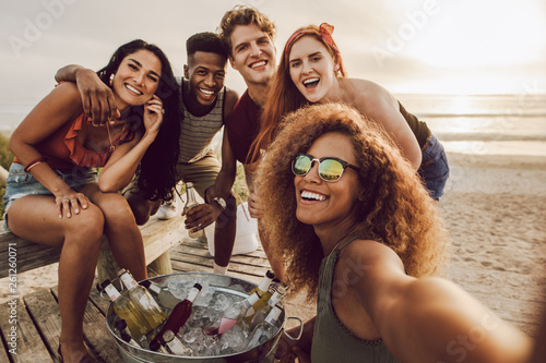Woman talking selfie with friends at the beach party
