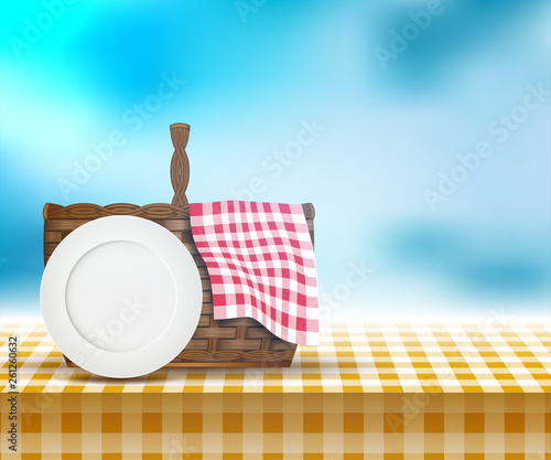 Picnic basket on table and spring landscape