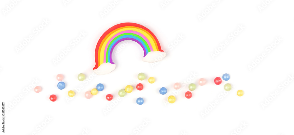 Obraz premium rainbow and colorful topping sprinkles. colorful rainbow and jelly beans on white background. creative idea of design holiday, festive, vacation, weather