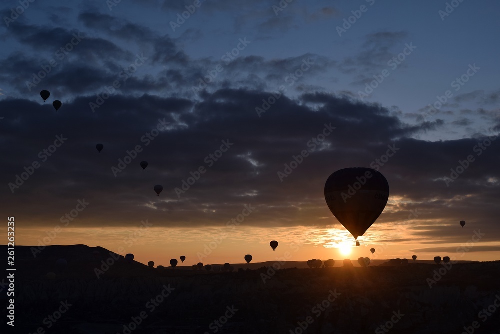 Sunrise and balloons. Beautiful background of the balloon and the sunset.Cappadocia. Turkey. Göreme. Nevşehir. Türkiye. 8. 04. 2019. Balloons flying over the rocky landscape in Cappadocia Turkey. View Sunrise and balloons. Beautiful background of the balloon and the sunset.Cappadocia. Turkey. Göreme. Nevşehir. Türkiye. 8. 04. 2019. Balloons flying over the rocky landscape in Cappadocia Turkey. View