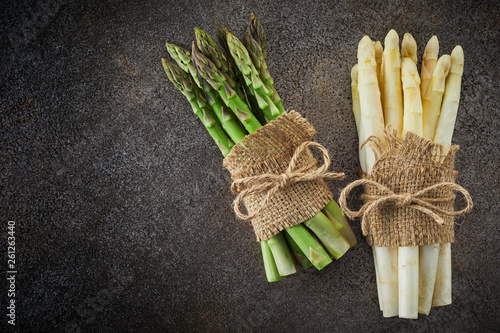 Two bundles of fresh asparagus tied with hessian