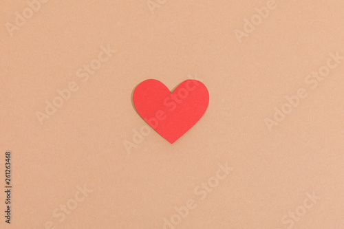 Top view of red paper heart on brown surface