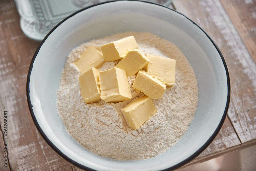 Flour and butter in a bowl to prepare the dough. cheese cake Flour and butter in a bowl to prepare the dough. cheese cake