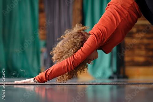 woman practicing yoga Downward facing dog exercise, adho mukha svanasana pose photo