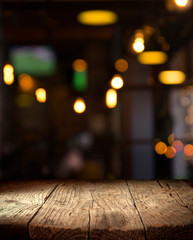 blurred background of bar and dark brown desk space of retro wood