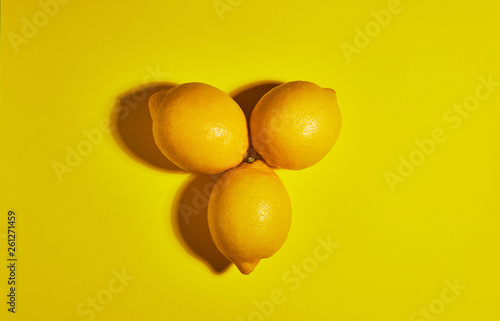 Lemon on yellow background. Flat lay, top view, copy space . Food concept.