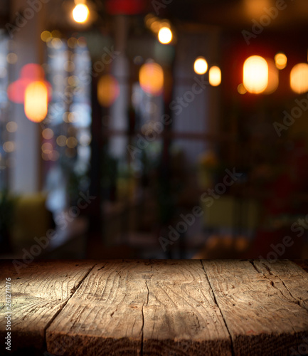 blurred background of bar and dark brown desk space of retro wood photo