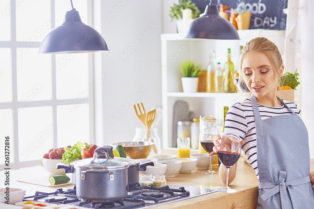 beautiful young woman using a digital tablet in the kitchen beautiful young woman using a digital tablet in the kitchen