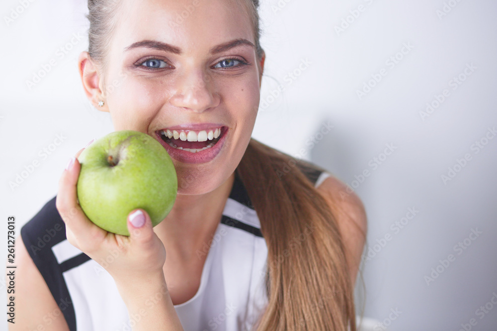 Young beautiful smiling girl with a green apple in hands Young beautiful smiling girl with a green apple in hands