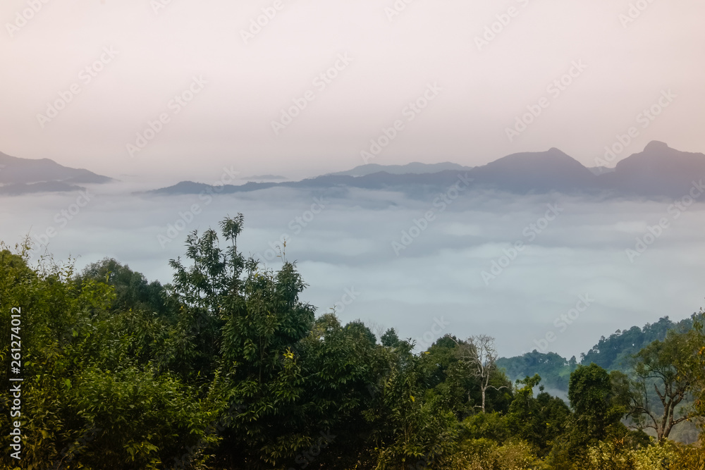 Sea of clouds at the dawn with a view of mountain range in the background, Nanthaburi National Park. Nan province, Thailand.