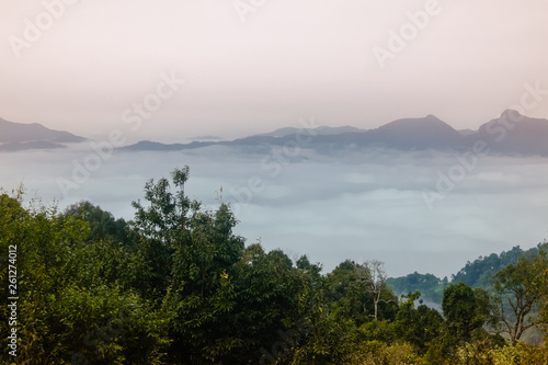 Sea of clouds at the dawn with a view of mountain range in the background, Nanthaburi National Park. Nan province, Thailand.