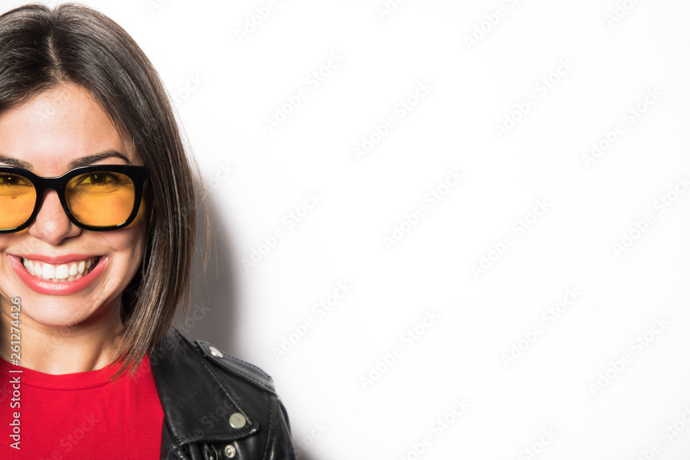 young woman wearing yellow sunglasses with a wihte background young woman wearing yellow sunglasses with a wihte background