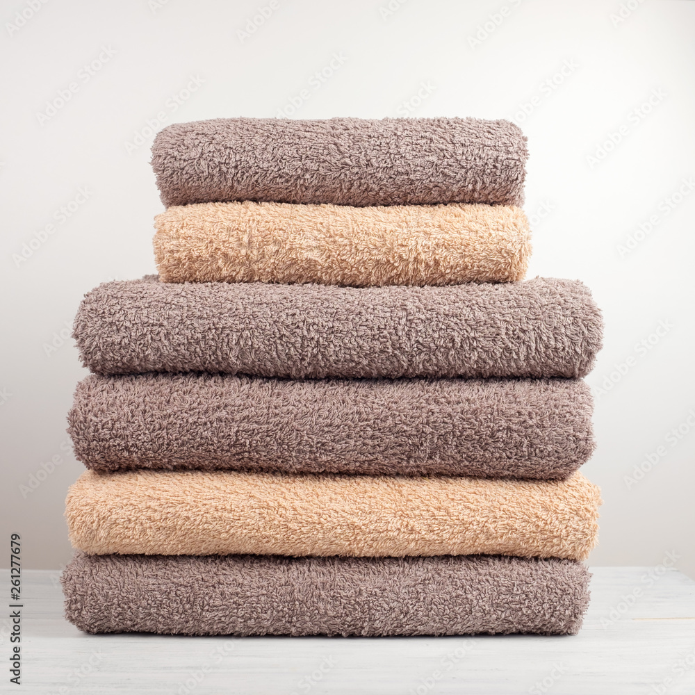A stack of fresh bath towels folded on the table. A stack of fresh bath towels folded on the table.