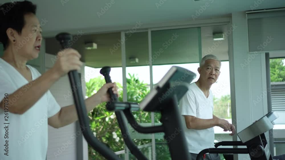 Asian elderly couple exercise together in modern luxury reacreation wellness gym Asian elderly couple exercise together in modern luxury reacreation wellness gym