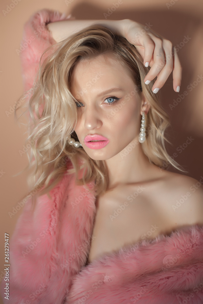 Young sexy girl in a pink coat, blonde in a fur coat. Young sexy girl in a pink coat, blonde in a fur coat.