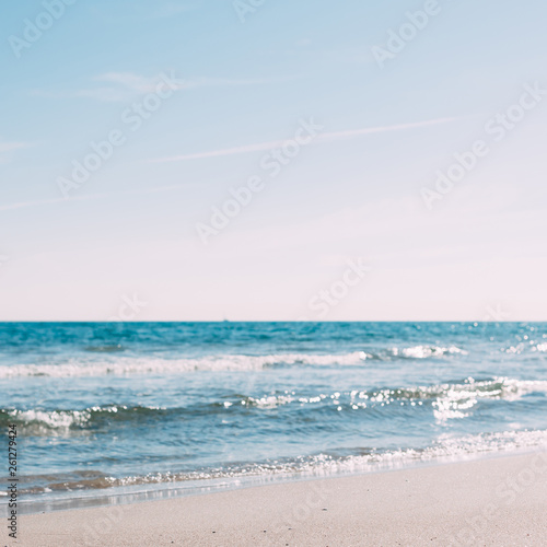 Summer sand beach and seashore waves background © dvoevnore