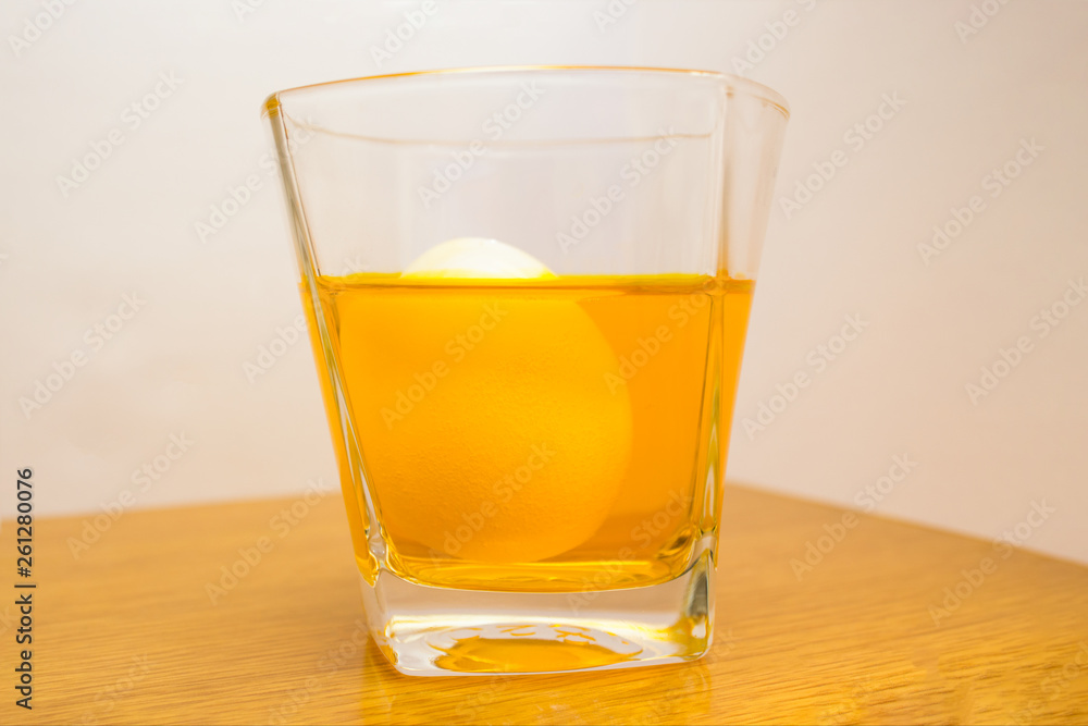 painting egg in ombre style in yellow color in a glass in process painting egg in ombre style in yellow color in a glass in process
