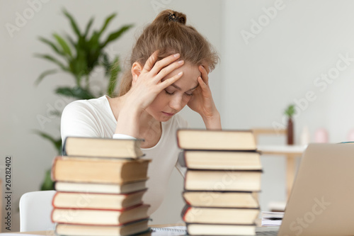 Upset woman sitting with closed eyes, annoyed by learning