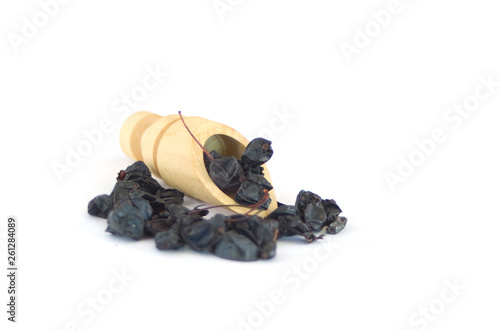 Dried Berberis berries isolated with wooden sppon on white photo