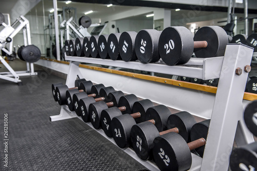 Dumbells in gym, sportive equipment close up