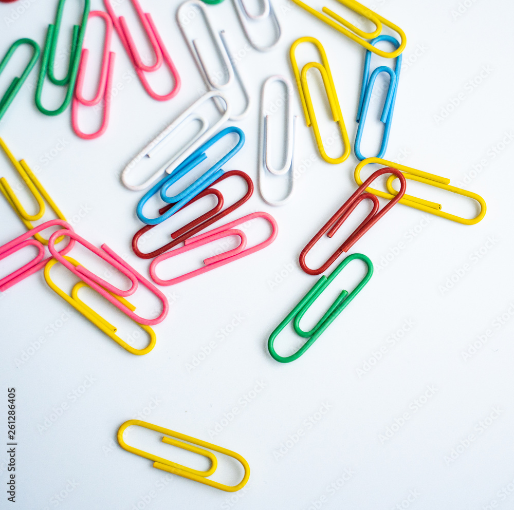 colored clips scattered randomly on white background colored clips scattered randomly on white background