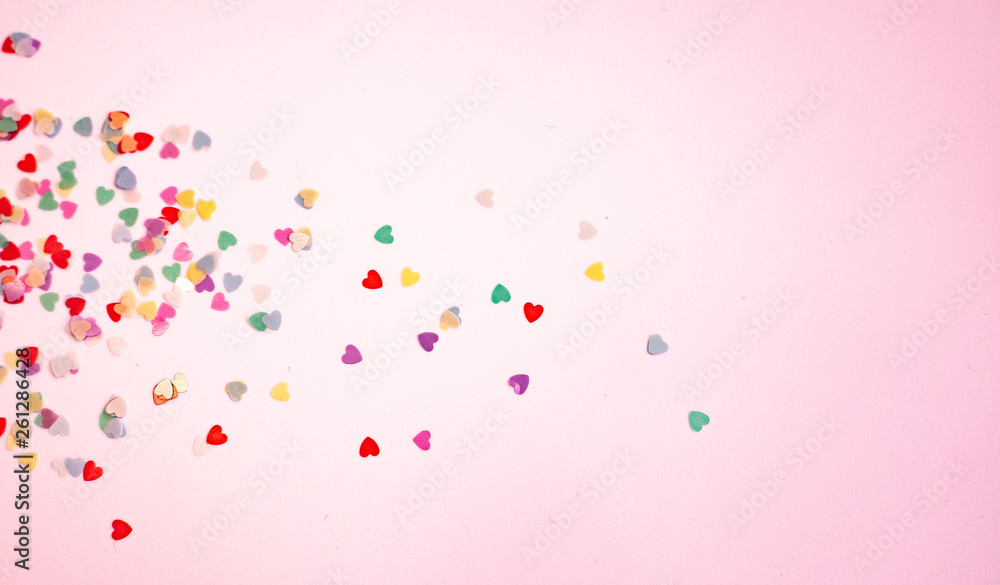 colored Sequin scattered on white background， with pink light