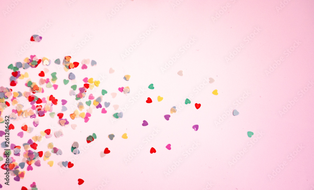 colored Sequin scattered on white background， with pink light