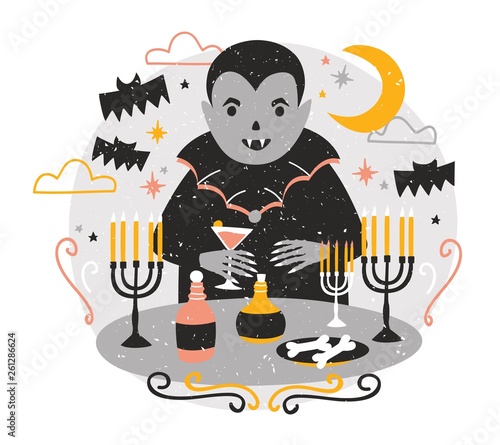 Adorable Dracula or funny vampire standing at table with candles in candlesti...