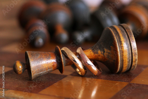 Wedding rings on old wooden chess