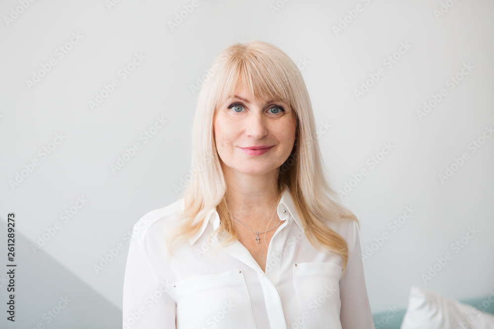 portrait aged blond woman smiling looking at the camera portrait aged blond woman smiling looking at the camera