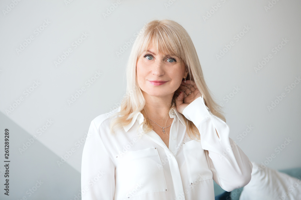 portrait aged blond woman smiling looking at the camera portrait aged blond woman smiling looking at the camera