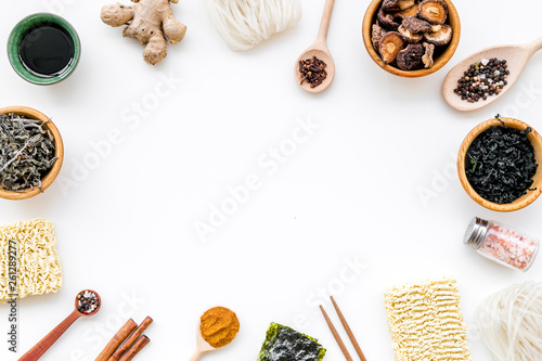 Geometric design with Chinese, Japanese products, noodles, weeds, spices, mushrooms on white background top view mockup