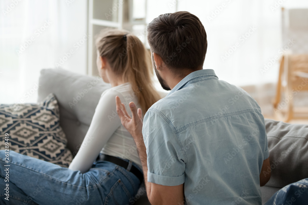 Angry man shouting at woman, sitting separately, relationships problem