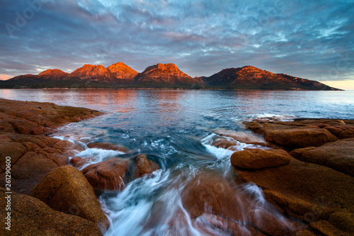 Sunset over The Hazards with Alpine glow and flowing water over rocks, Freycinet National Park, Coles Bay, Tasmania, Australia photo
