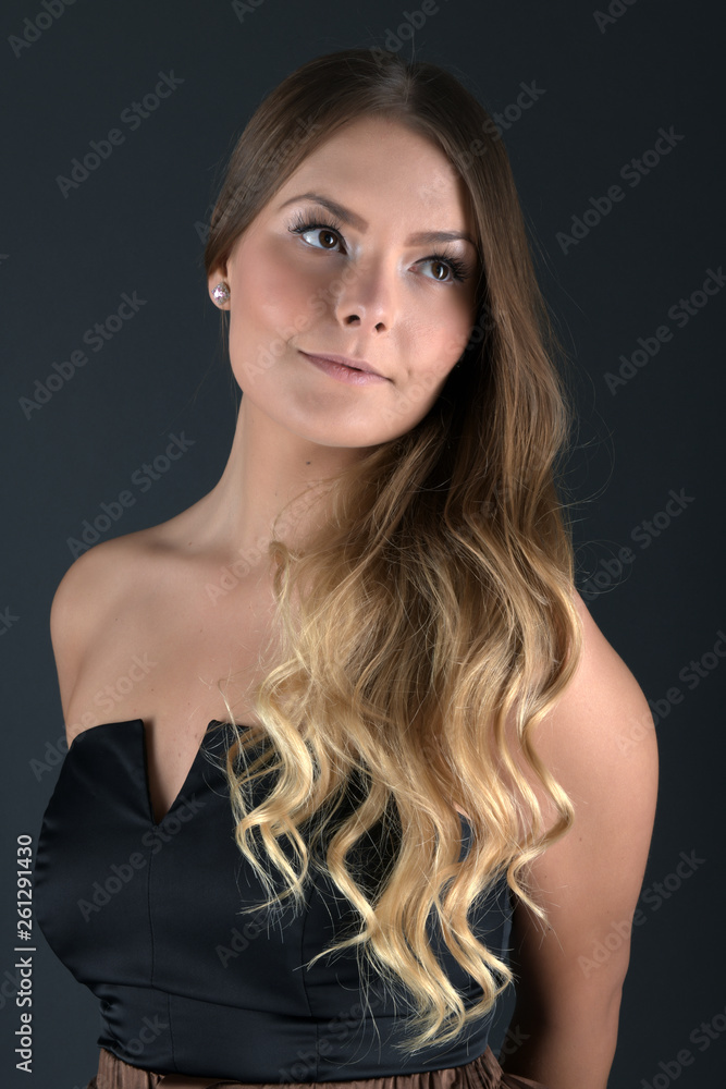 Beautiful smiling woman with clean skin, natural make-up, and white teeth on grey background Beautiful smiling woman with clean skin, natural make-up, and white teeth on grey background