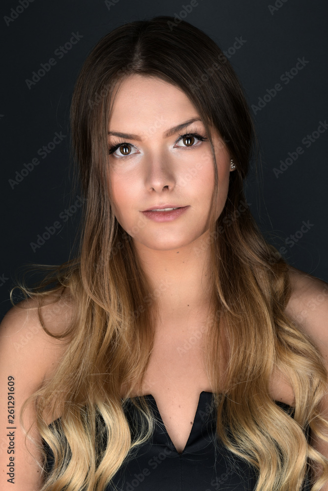 Beautiful smiling woman with clean skin, natural make-up, and white teeth on grey background Beautiful smiling woman with clean skin, natural make-up, and white teeth on grey background