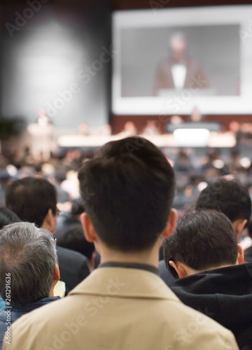 "Conference Speaker in Lecture Presentation Hall. Meeting with Executive Manager Audience in Auditorium. Corporate Event with Investors Listening to Expert Presenters. Tech Business Training Seminar.