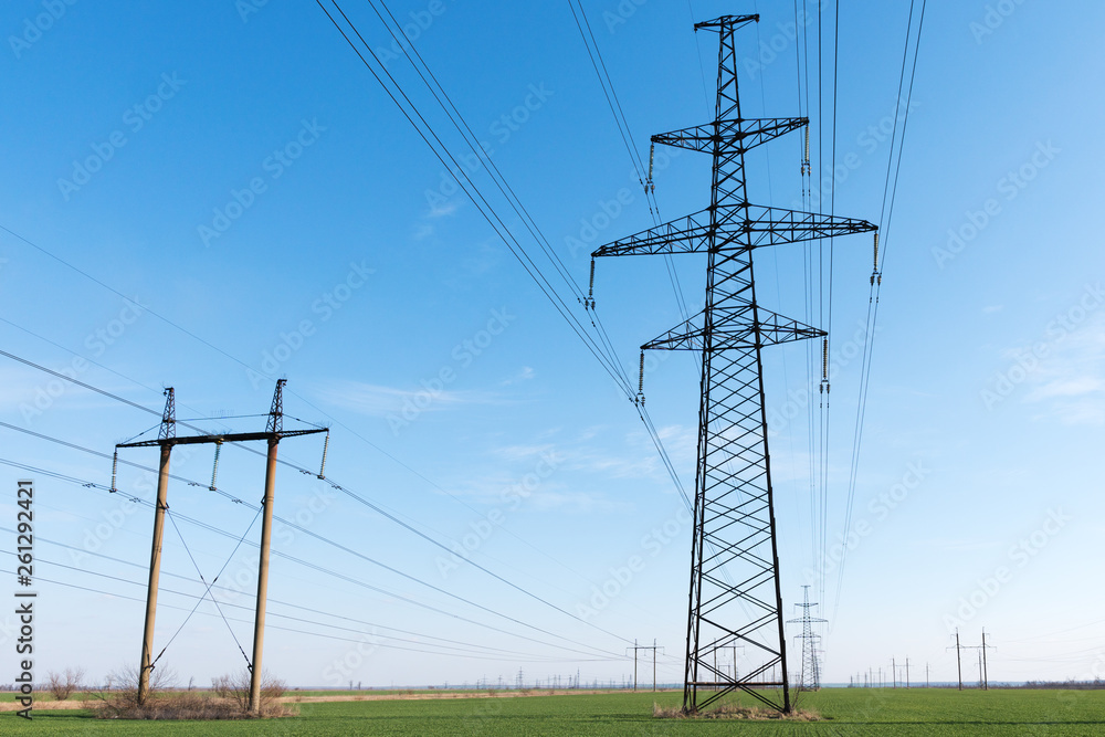 custom made wallpaper toronto digitalHigh voltage lines and power pylons and a green agricultural landscape on a sunny day.