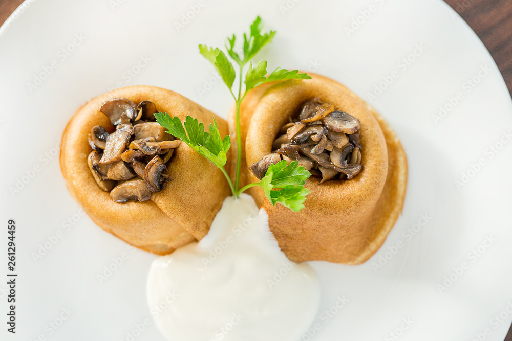Baked pancakes with mushrooms and onions