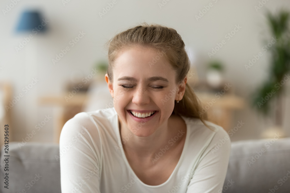 Close up attractive young woman laughing with closed eyes Close up attractive young woman laughing with closed eyes