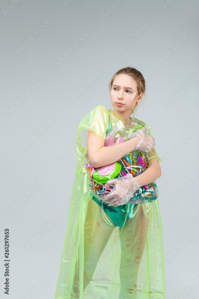 Model feeling motivated while posing with plastic in hands Model feeling motivated while posing with plastic in hands