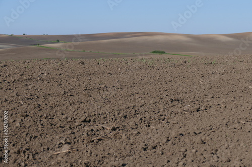 Agricultural land. Treated spacious field in the plane. Ploughing time. Spring.