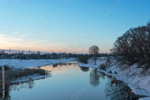 Beautiful spring landscape with a small quiet river in the evening. © Valery Smirnov