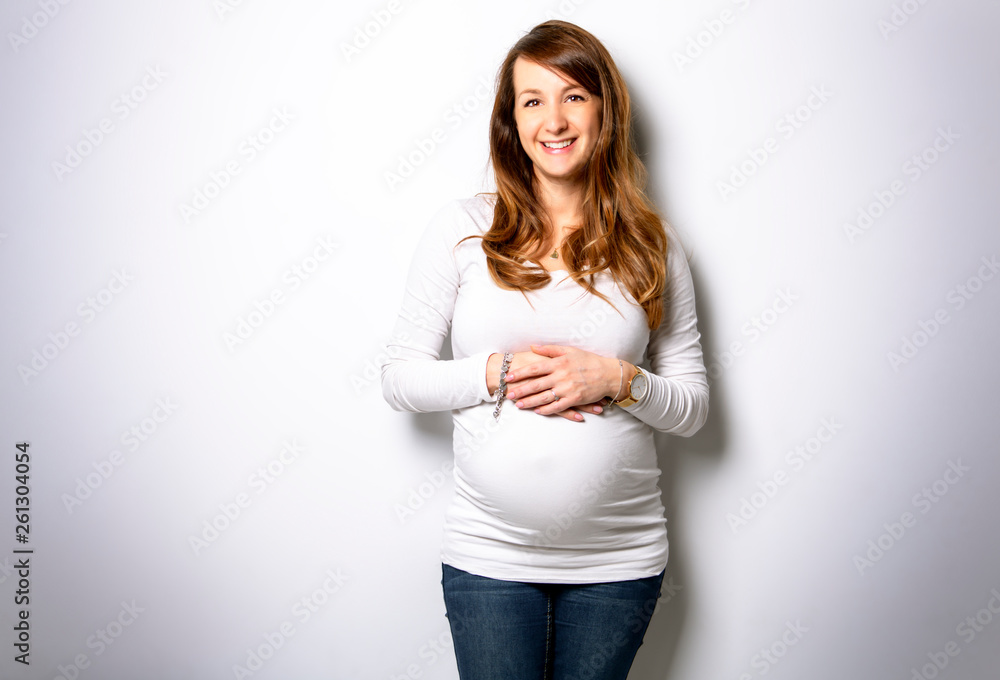A Portrait of adorable pregnant woman in white