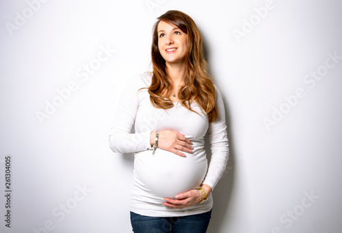 A Portrait of adorable pregnant woman in white