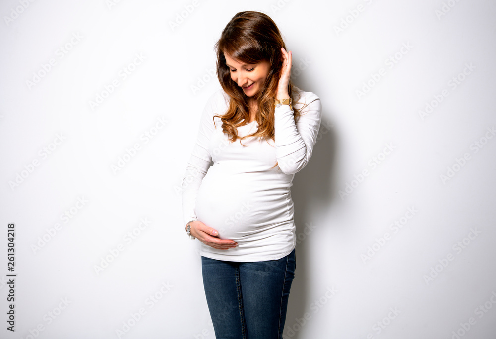 A Portrait of adorable pregnant woman in white A Portrait of adorable pregnant woman in white