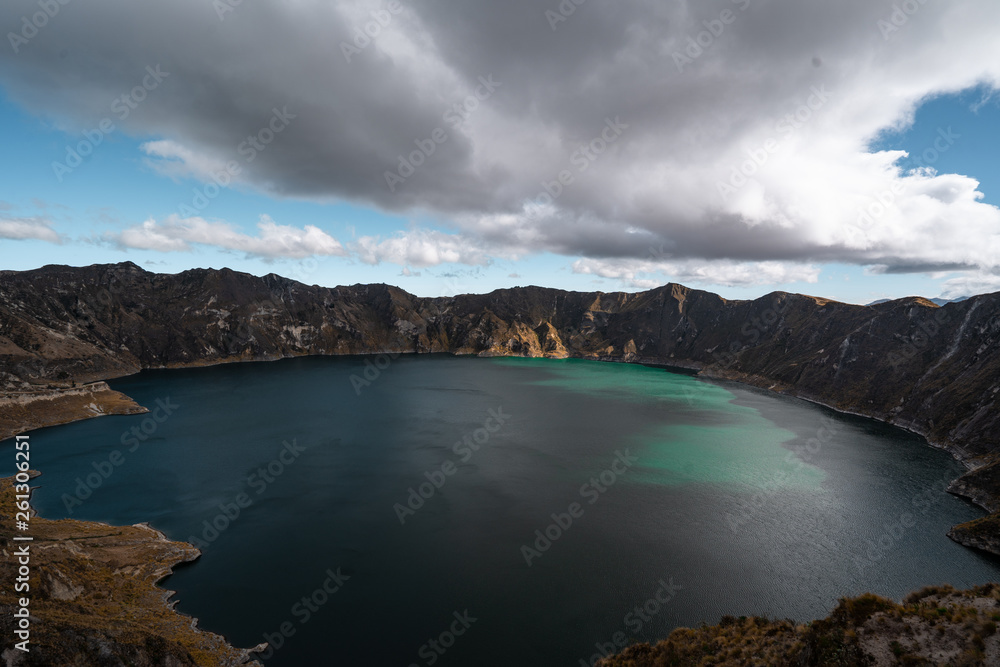 Quilotoa Ecuador lagoon in volcano with turquoise water. Visit beautiful places in the world and enjoy traveling to unique sights.